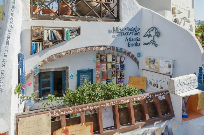 Cozy and grandiose library exterior with books and plants, showcasing a magical bookstore ambiance from around the world.