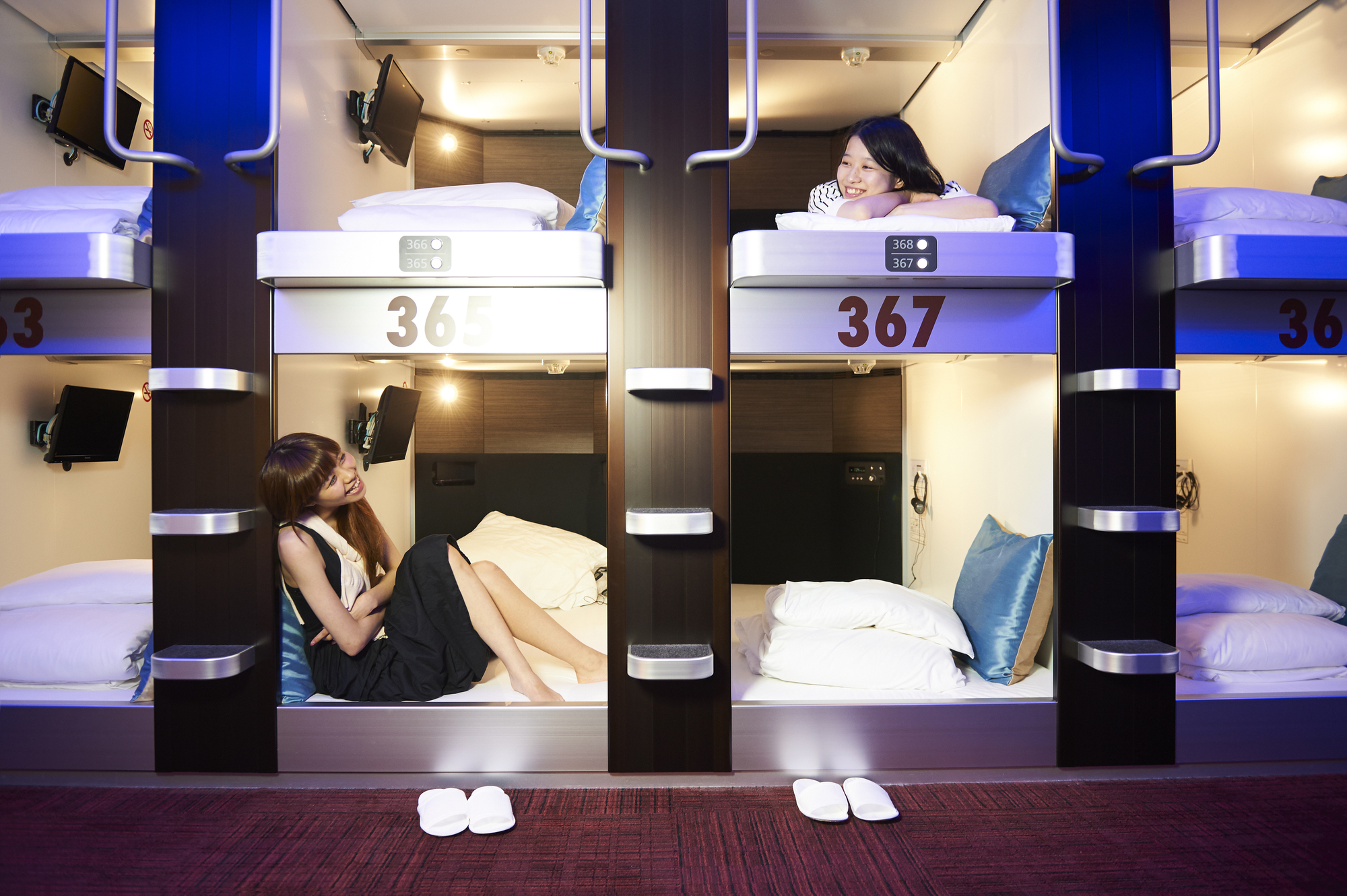 Two women in capsule hotel